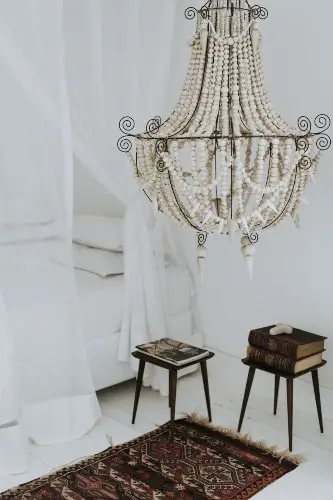 iron chandelier and traditional style rug