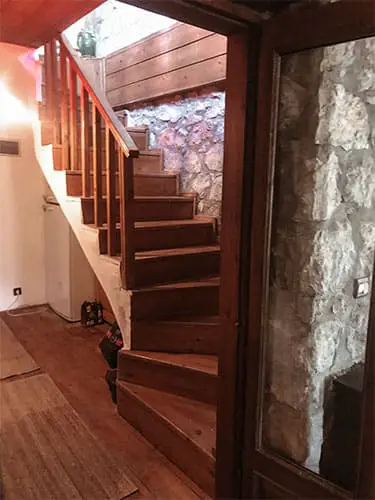 stone hosue with wood staircase